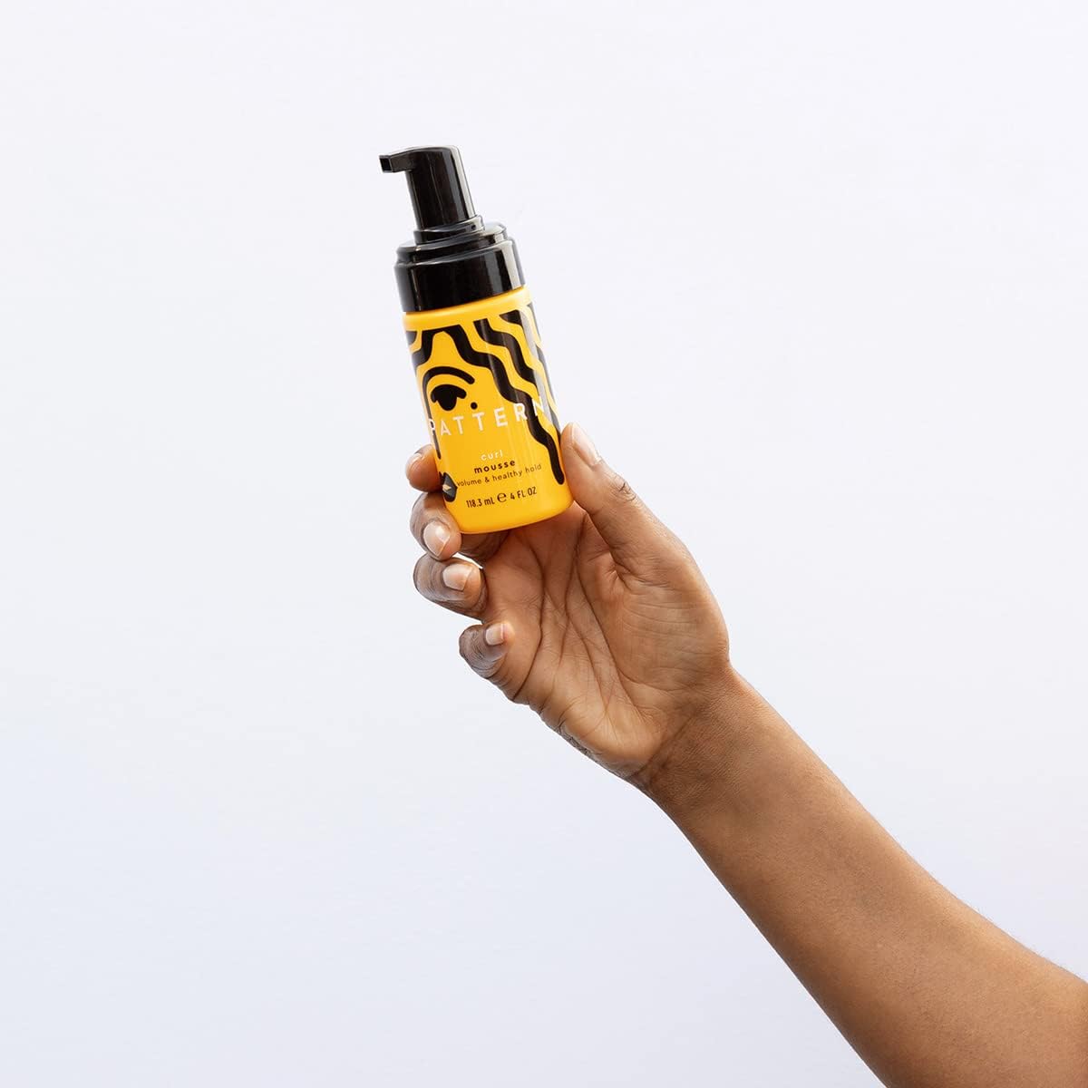 Pattern Beauty Curl Mousse by Tracee Ellis Ross, a styling product in a pump bottle, designed for defining and enhancing curls.