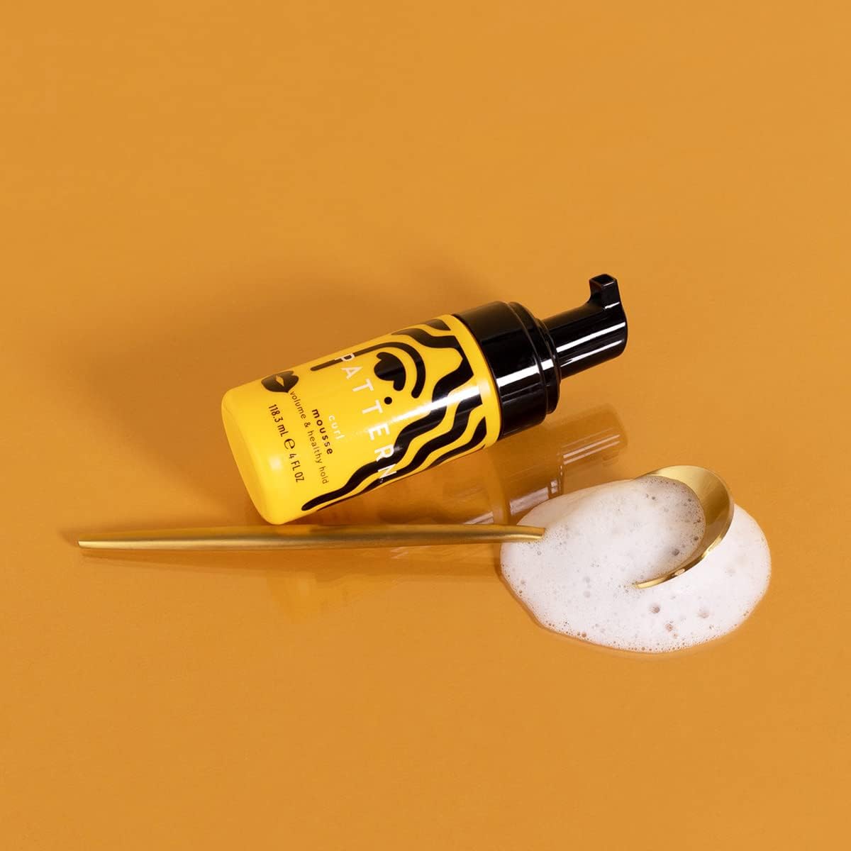 Pattern Beauty Curl Mousse bottle with pump dispenser, displaying the product label for curly hair styling by Tracee Ellis Ross.