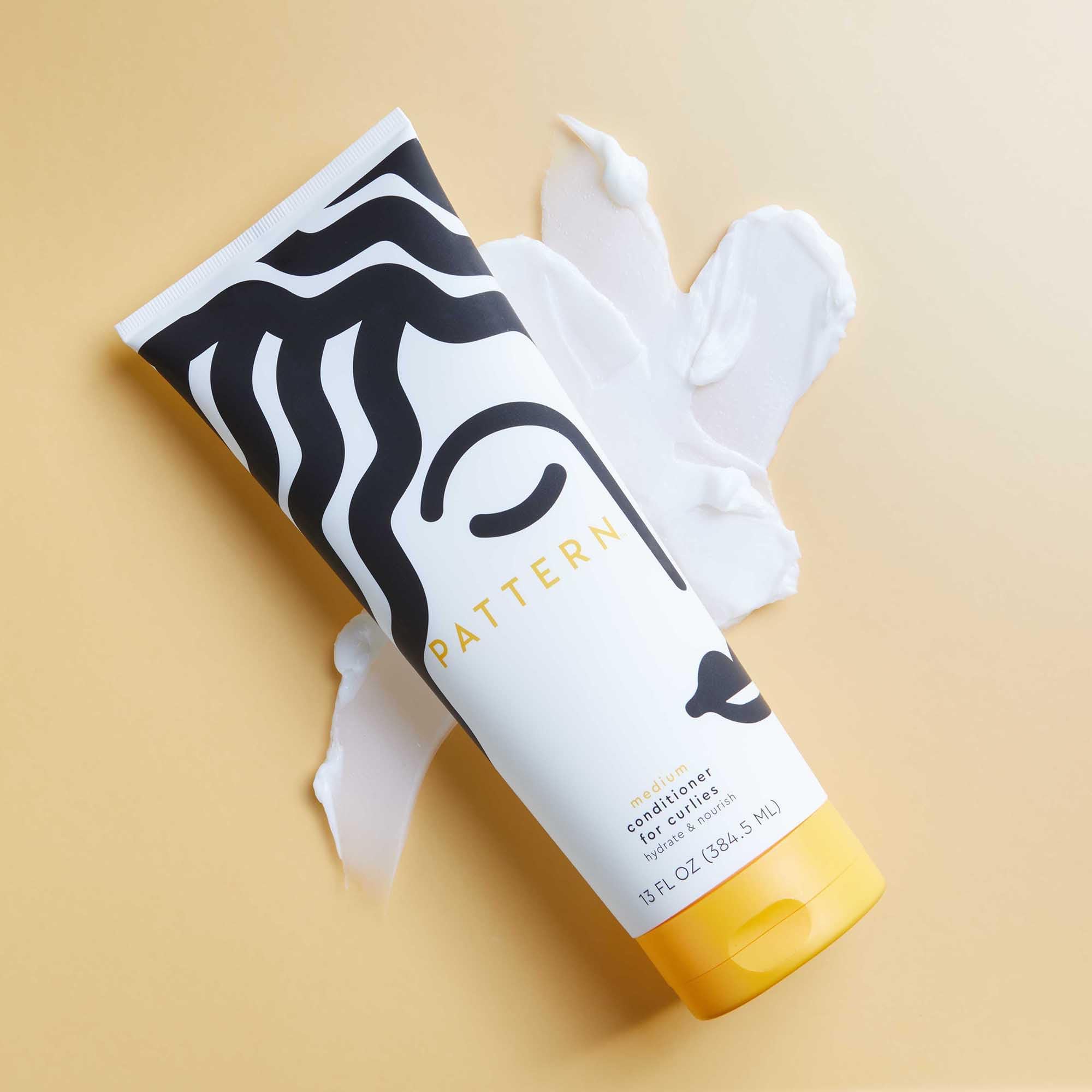 Pattern Beauty Medium Conditioner for curly hair, hydration and slip, with a white bottle featuring a pump dispenser.