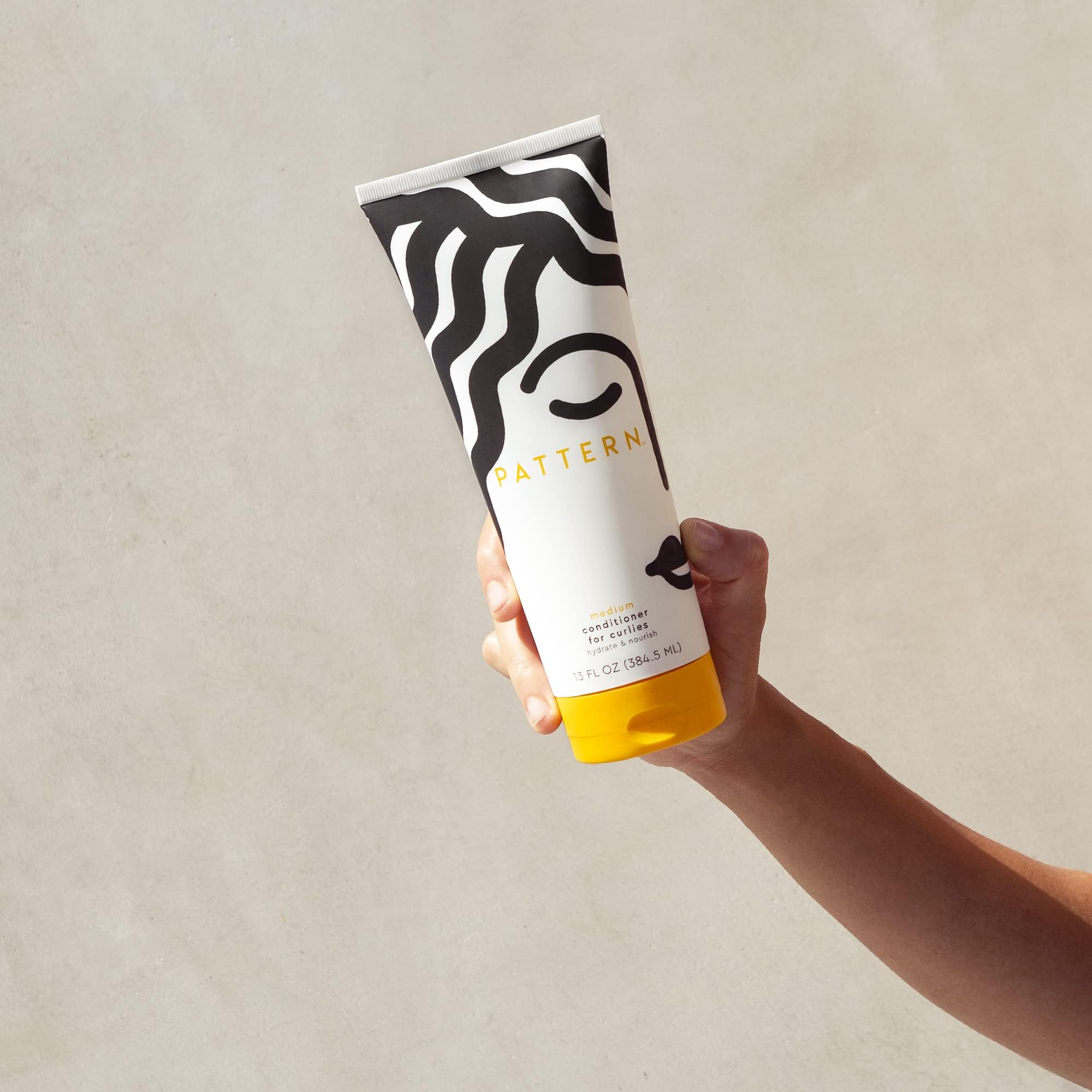 Pattern Beauty Medium Conditioner for curly hair, hydrating and slip-enhancing, in a sleek bottle with a pump dispenser.