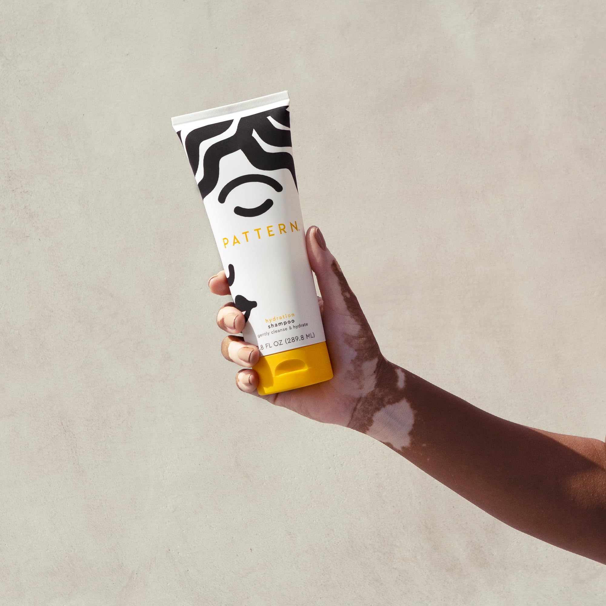 Pattern Beauty Hydration Shampoo bottle with label, featuring a sleek design and product details for curly hair hydration.