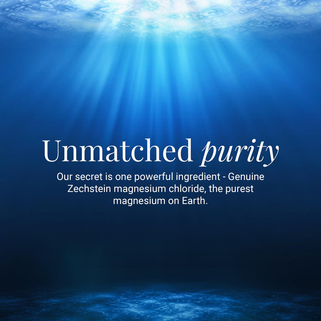 Ancient Minerals Magnesium Bath Flakes in a clear container, showing white mineral flakes for relaxing bath soak.