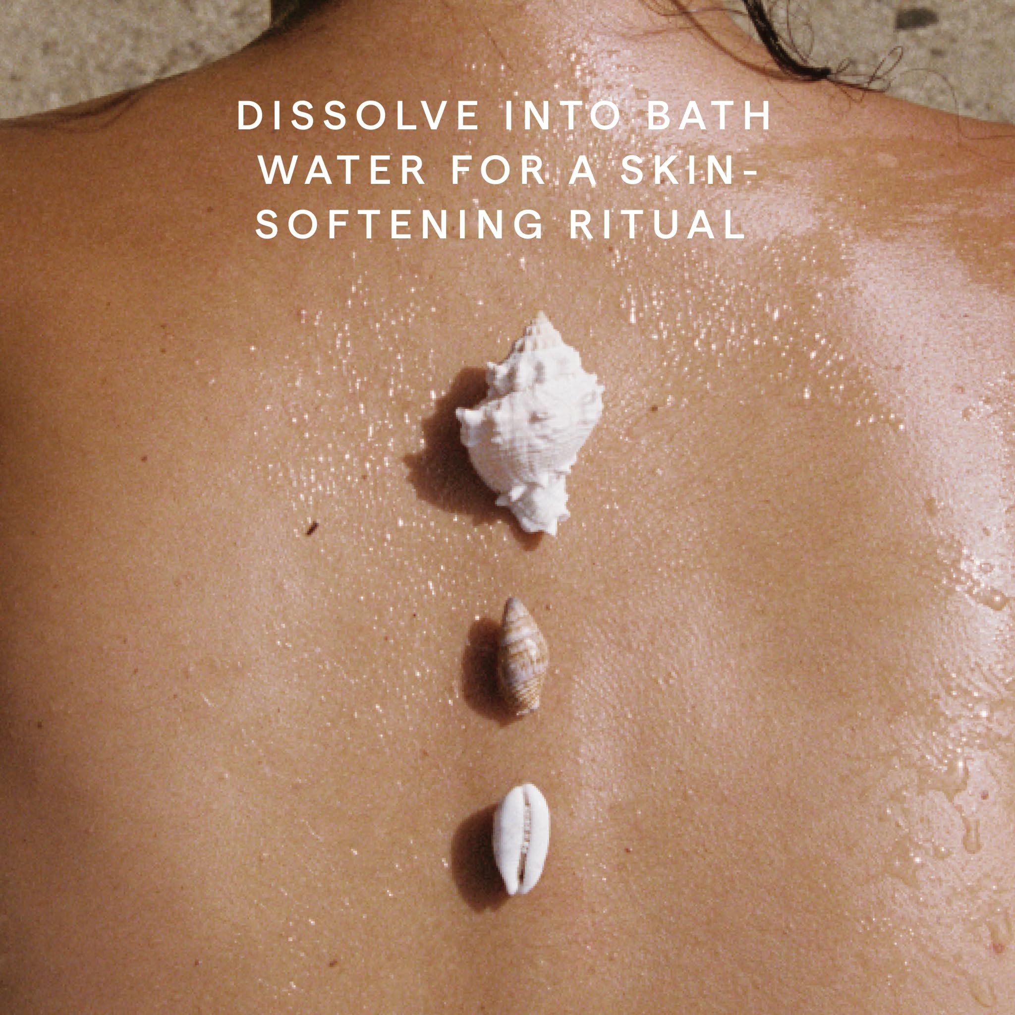 Herbivore Coconut Milk Bath Soak in a clear jar with a scoop, featuring white coconut milk bath salts and natural ingredients.