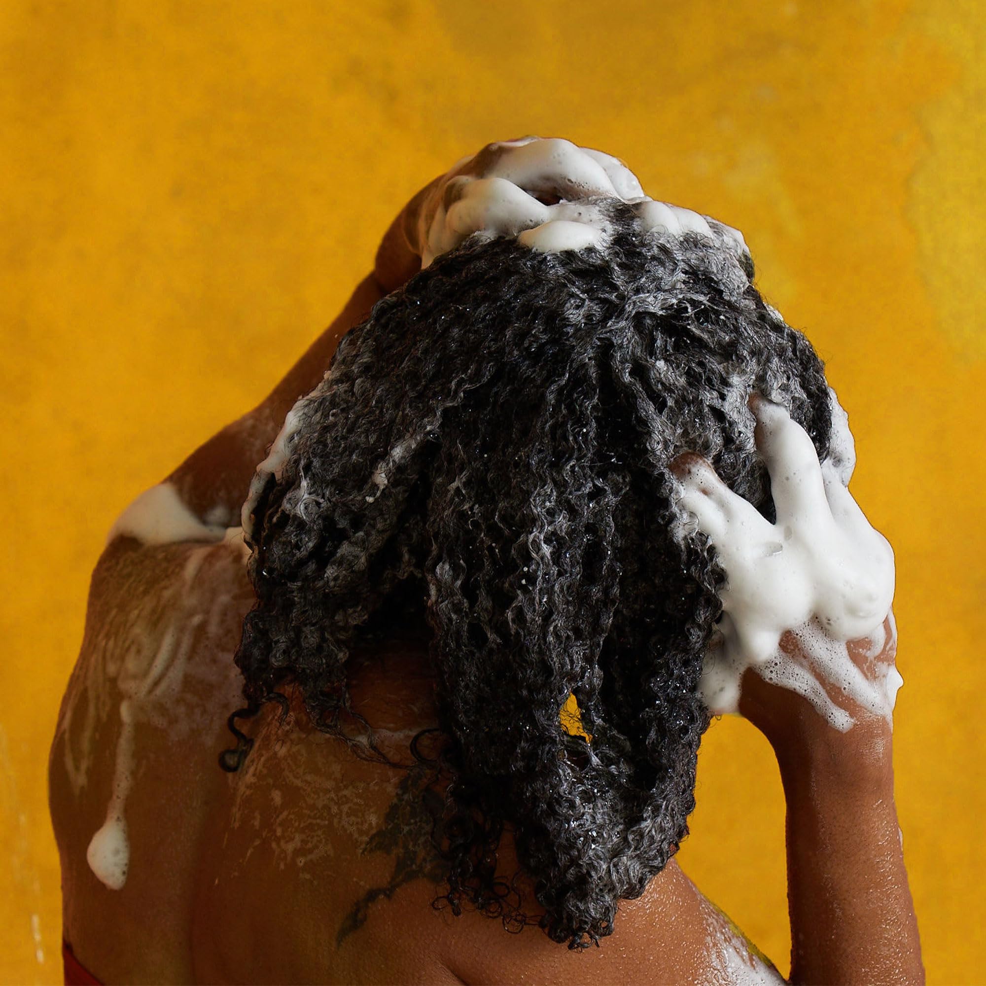 Pattern Beauty Hydration Shampoo bottle with label, designed for curly hair, featuring a sleek black and pink packaging.