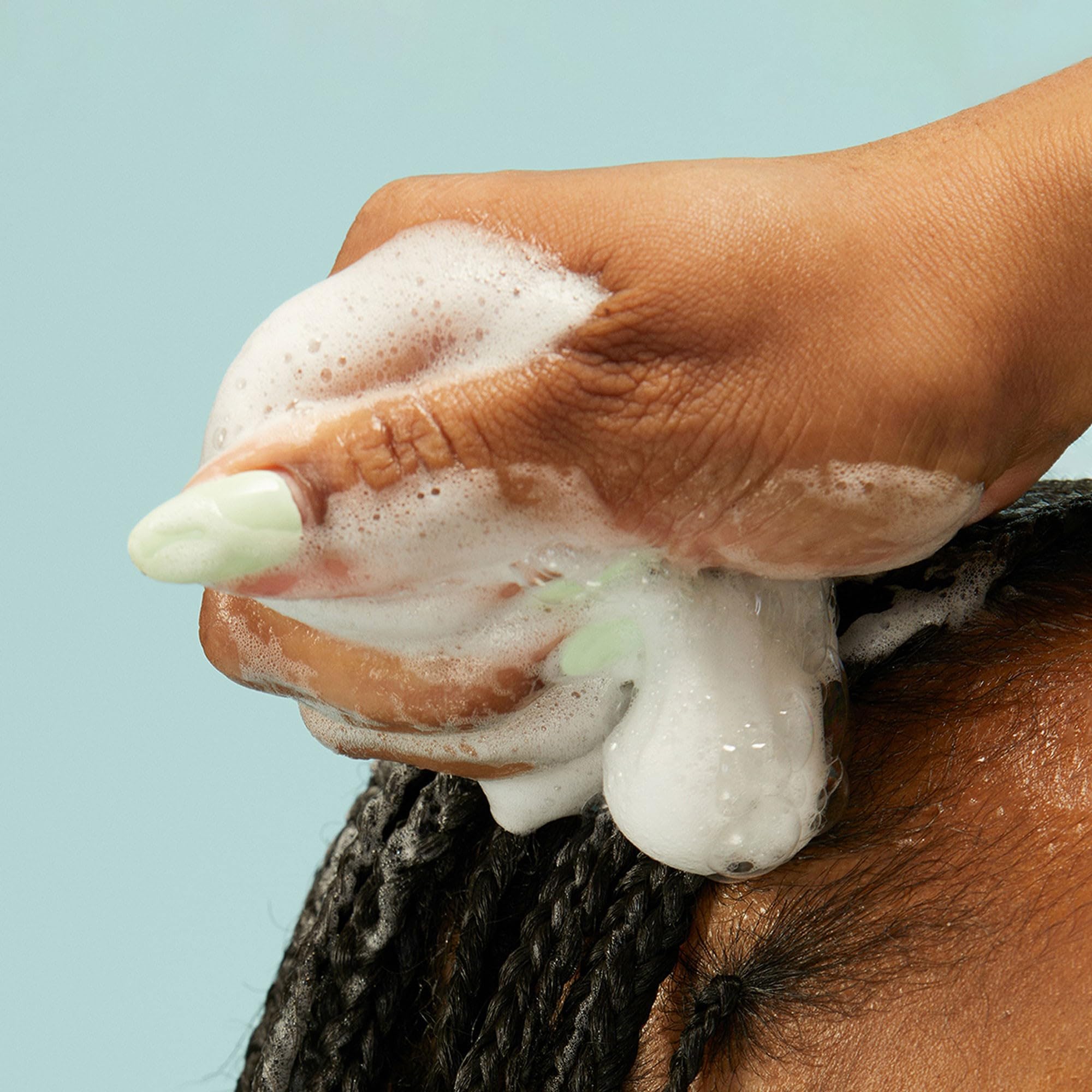 Pattern Beauty Curl Mousse in a clear bottle with a pump dispenser, designed for defining and enhancing curly hair.